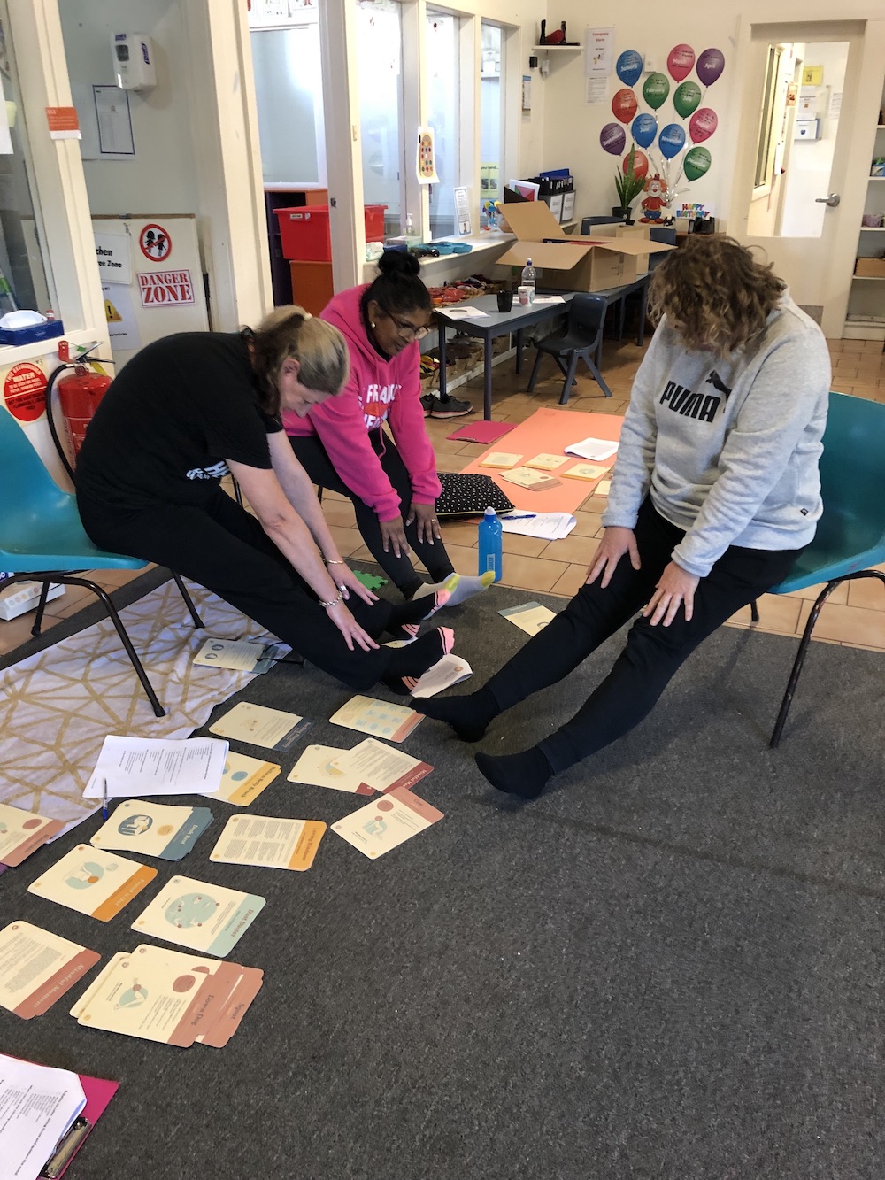 Preschool educators in a whole school workshop practising with The Karma Classroom Activity Cards